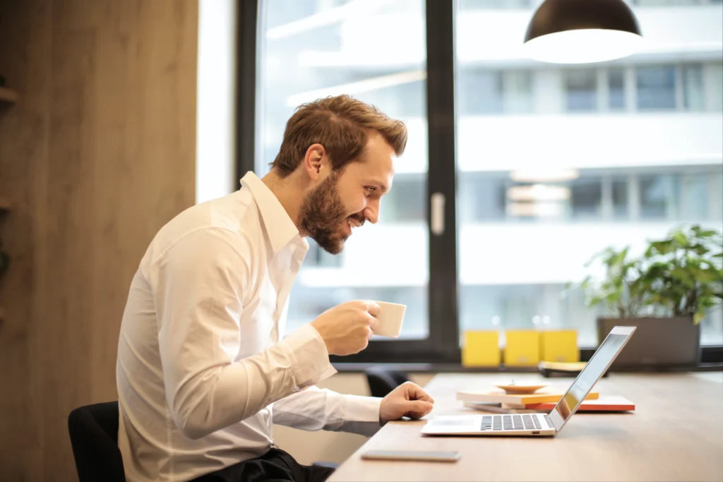 a man smiling looking at his computer